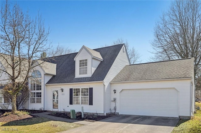 cape cod home featuring a garage, driveway, and a shingled roof