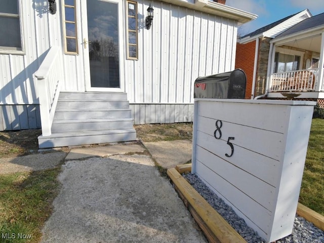 exterior details with board and batten siding and entry steps