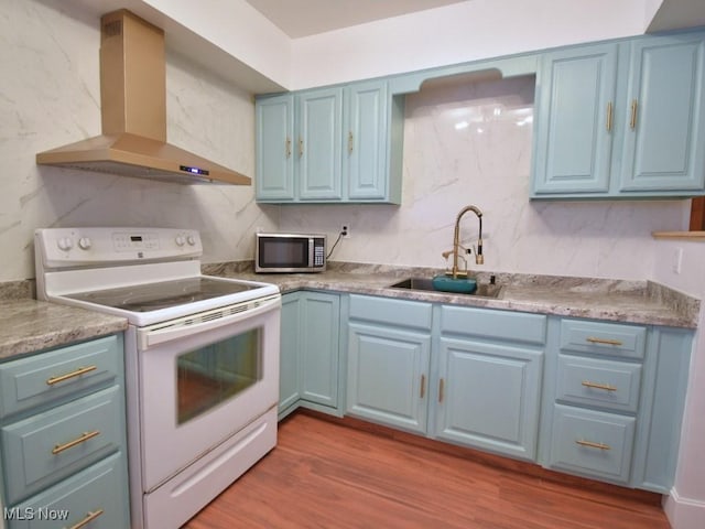 kitchen with ventilation hood, a sink, stainless steel microwave, blue cabinets, and white range with electric stovetop