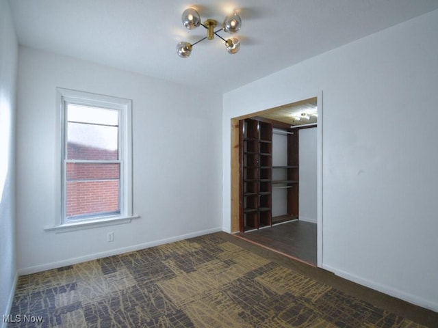 spare room with carpet flooring and baseboards