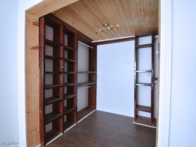 corridor featuring dark wood finished floors and wooden ceiling