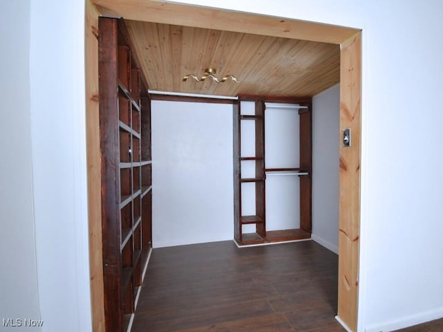 corridor with wood ceiling, baseboards, and wood finished floors