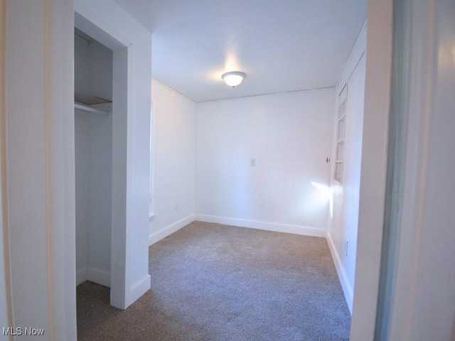 unfurnished bedroom featuring baseboards and carpet