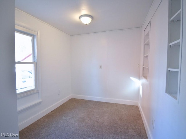 unfurnished room featuring baseboards and carpet floors