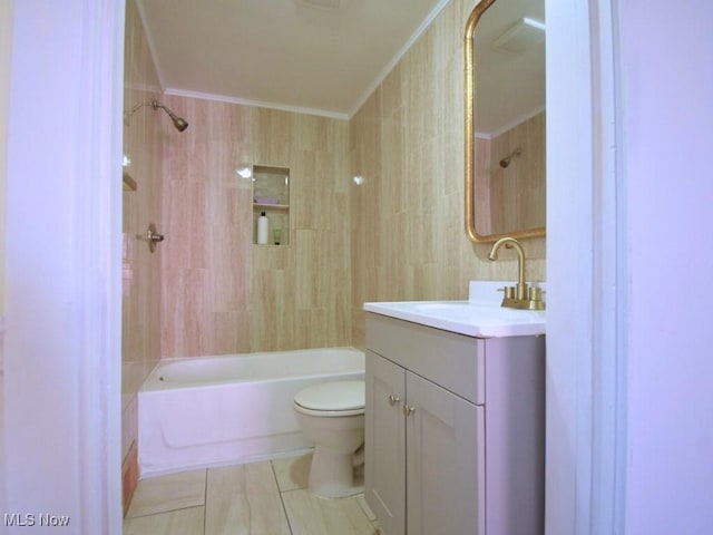 full bath with toilet, ornamental molding, shower / bathing tub combination, tile walls, and vanity