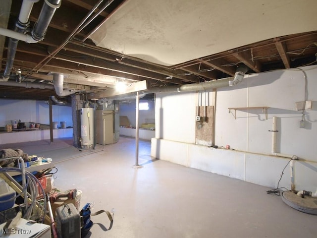 unfinished below grade area featuring water heater