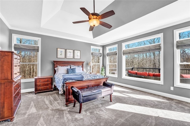 bedroom with a raised ceiling, ornamental molding, carpet, baseboards, and ceiling fan