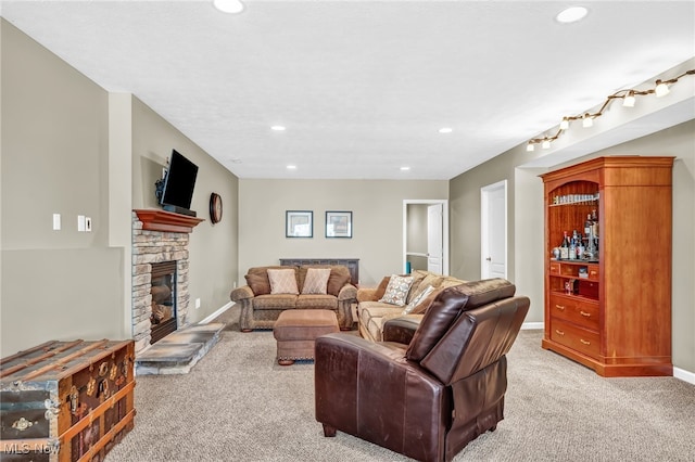 living room with recessed lighting, light colored carpet, and a fireplace