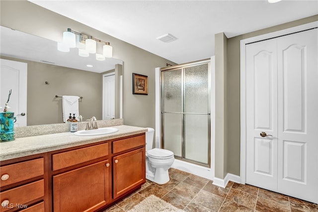 full bath with visible vents, toilet, a stall shower, and vanity