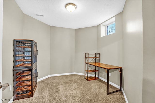 interior space featuring visible vents, baseboards, and carpet