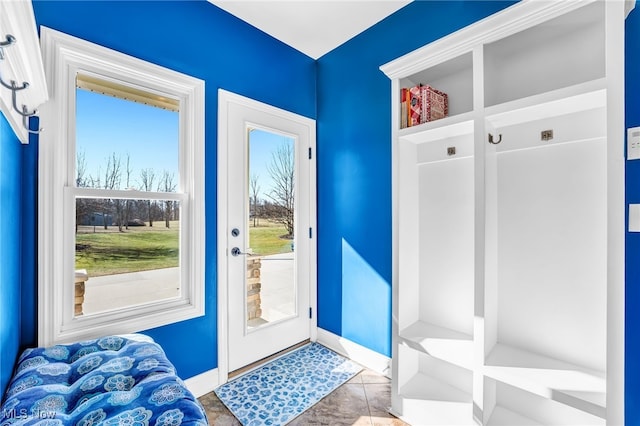 mudroom with tile patterned flooring and baseboards