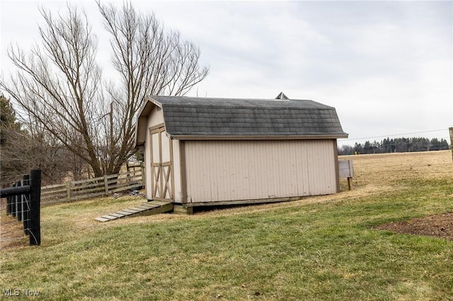 view of shed featuring fence