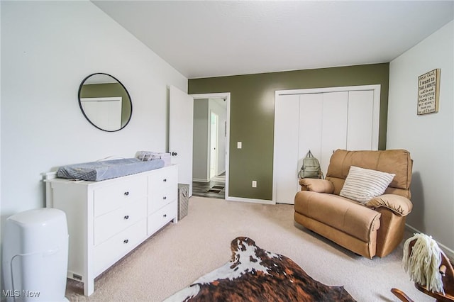 sitting room featuring baseboards and light carpet