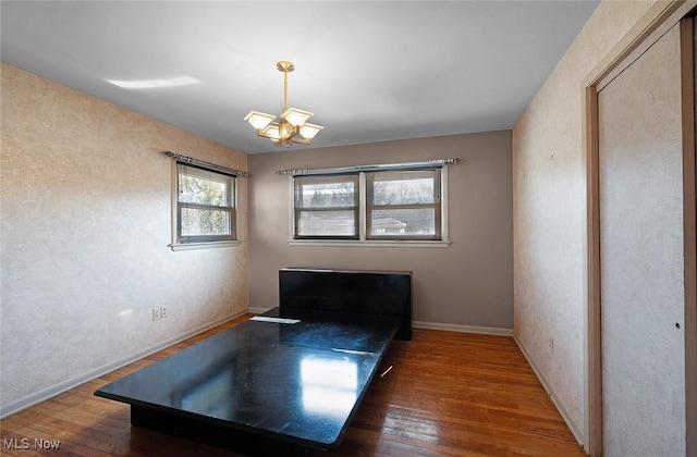 unfurnished room featuring baseboards and hardwood / wood-style floors