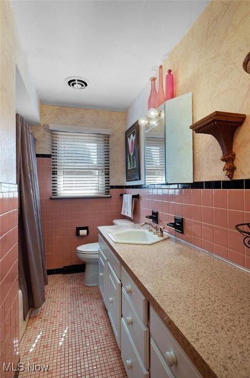 full bath featuring vanity, visible vents, tile walls, toilet, and tile patterned floors