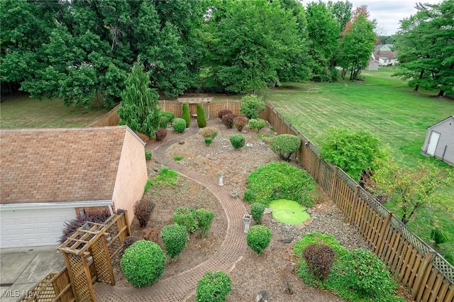 view of yard featuring a garage and fence