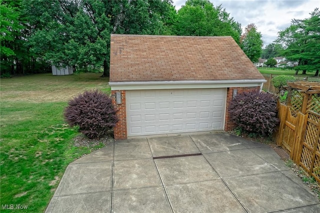 detached garage featuring fence