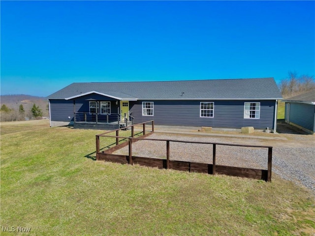 back of property featuring a yard and fence