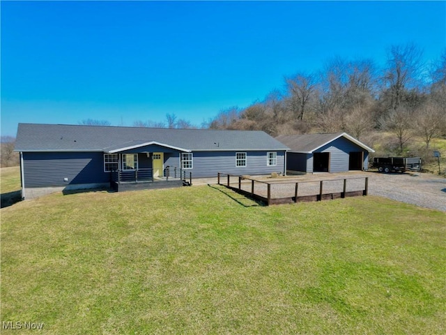 view of front of house with a front yard and an outdoor structure