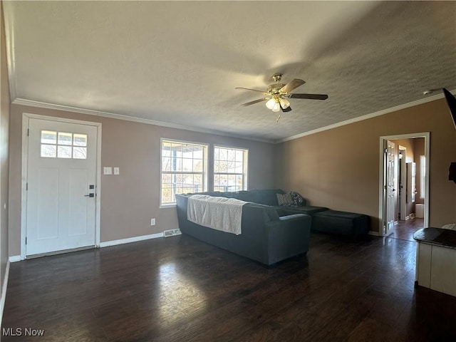 living area with crown molding, baseboards, ceiling fan, dark wood finished floors, and a textured ceiling