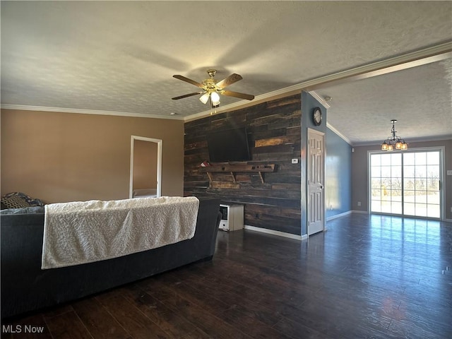 living area featuring wood finished floors, crown molding, ceiling fan with notable chandelier, and a textured ceiling