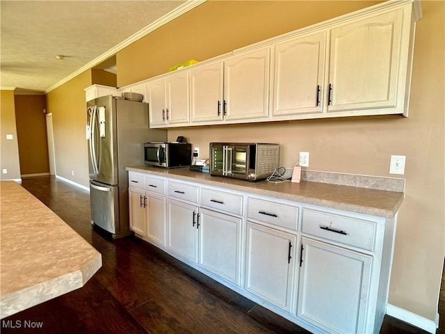 kitchen featuring crown molding, light countertops, dark wood-style floors, white cabinets, and stainless steel appliances