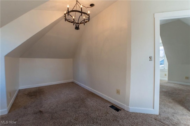 bonus room featuring baseboards, lofted ceiling, carpet, and a chandelier