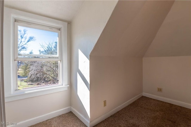 bonus room with baseboards, carpet flooring, and vaulted ceiling