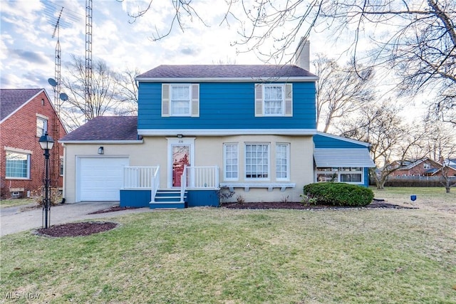 colonial home featuring driveway, an attached garage, a chimney, and a front yard