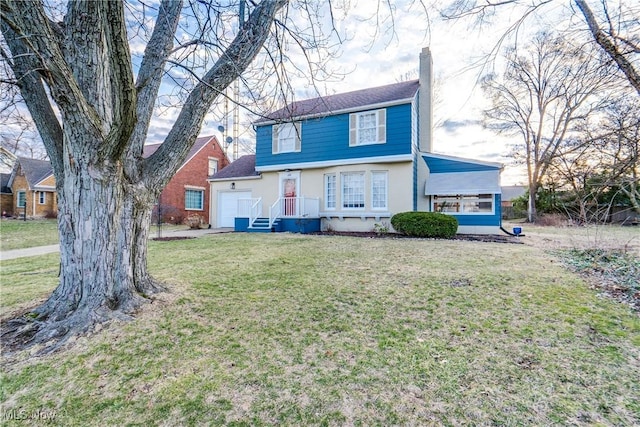 view of front of house featuring stucco siding, an attached garage, a chimney, and a front lawn