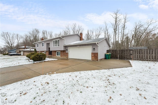 view of front of house featuring fence, driveway, an attached garage, a chimney, and brick siding