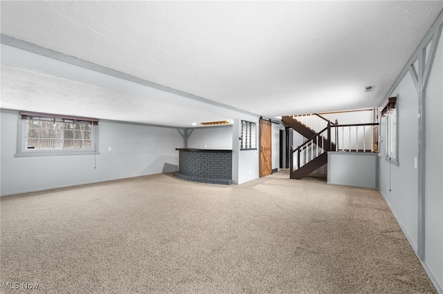 interior space featuring stairs, visible vents, and a textured ceiling