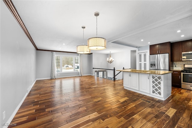 kitchen with dark wood-style floors, decorative backsplash, stainless steel appliances, and baseboards