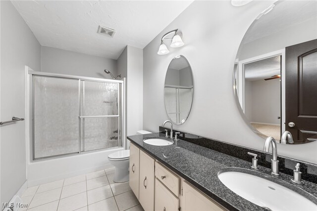 bathroom with tile patterned flooring, visible vents, toilet, and a sink