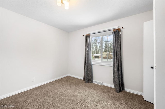 unfurnished room with visible vents, carpet floors, and baseboards