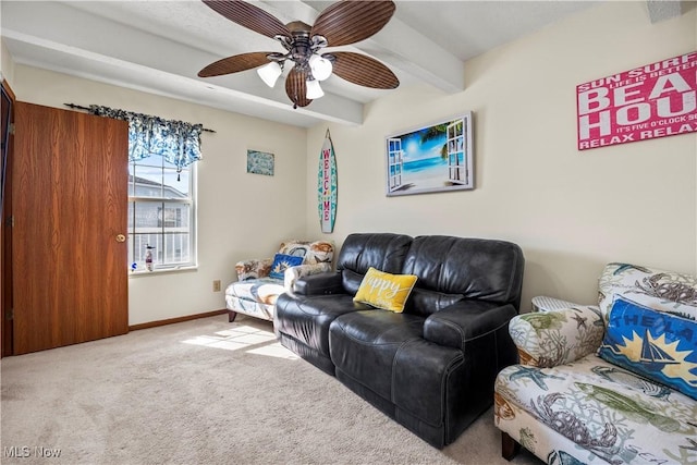 living room with beamed ceiling, baseboards, carpet, and a ceiling fan