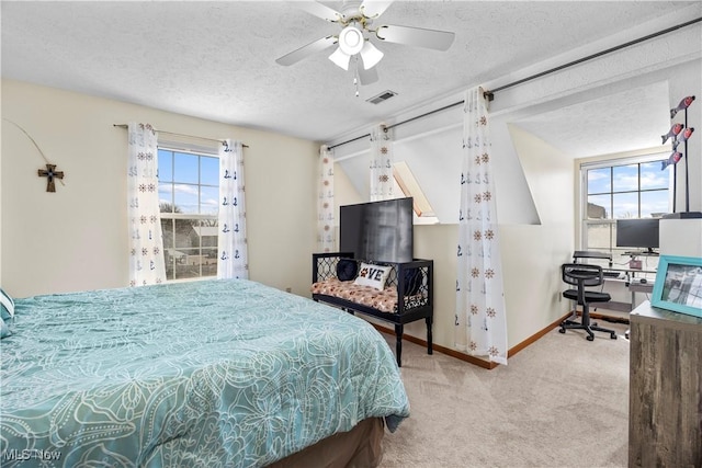 bedroom with visible vents, multiple windows, a textured ceiling, and carpet