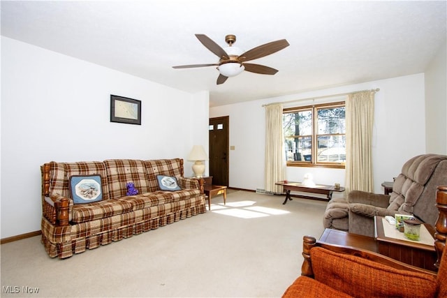 living area featuring a ceiling fan, carpet, and baseboards