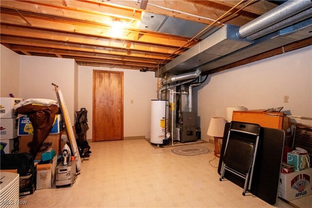 unfinished below grade area with water heater, heating unit, and tile patterned floors