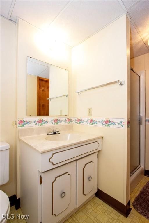 full bathroom featuring vanity, tile patterned floors, toilet, and a shower stall