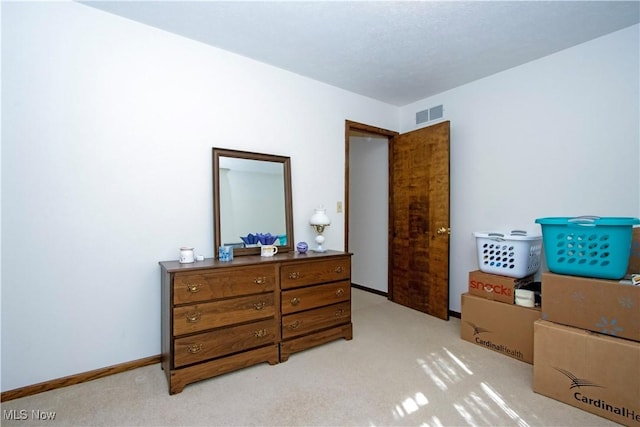 bedroom featuring light colored carpet, visible vents, and baseboards