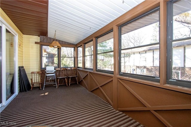 unfurnished sunroom featuring a wealth of natural light and lofted ceiling