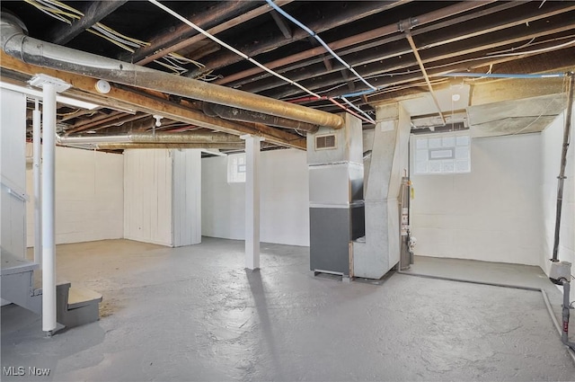 basement with heating unit and visible vents