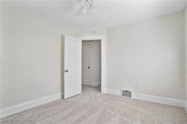 empty room featuring visible vents, baseboards, ceiling fan, and carpet flooring