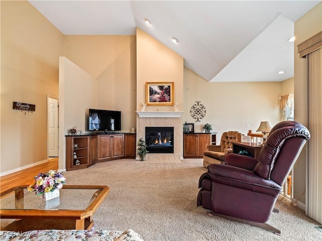 living room featuring light carpet, a fireplace, baseboards, and high vaulted ceiling