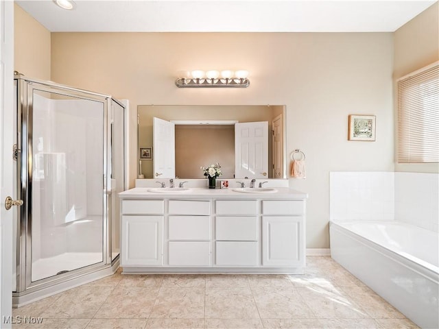 full bath with double vanity, a stall shower, a garden tub, and a sink