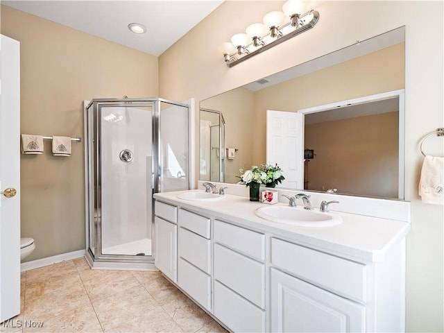 bathroom featuring tile patterned flooring, a shower stall, and a sink