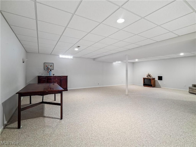 finished basement featuring recessed lighting, a paneled ceiling, and baseboards