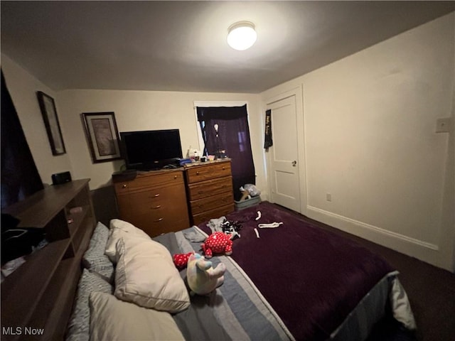 carpeted bedroom featuring baseboards