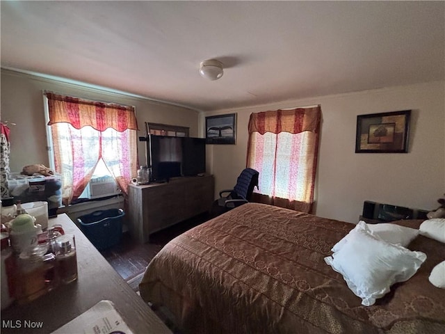 bedroom featuring cooling unit and wood finished floors